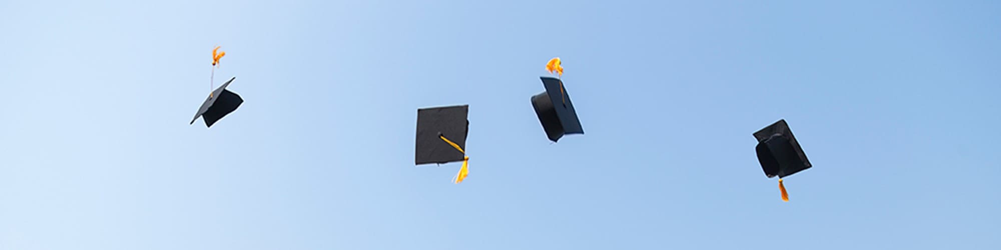 Graduation caps in the air