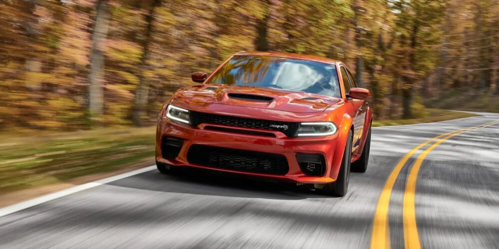 2023 Dodge charger driving through forested area