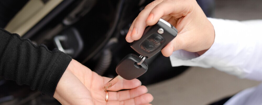 Person handing over car keys