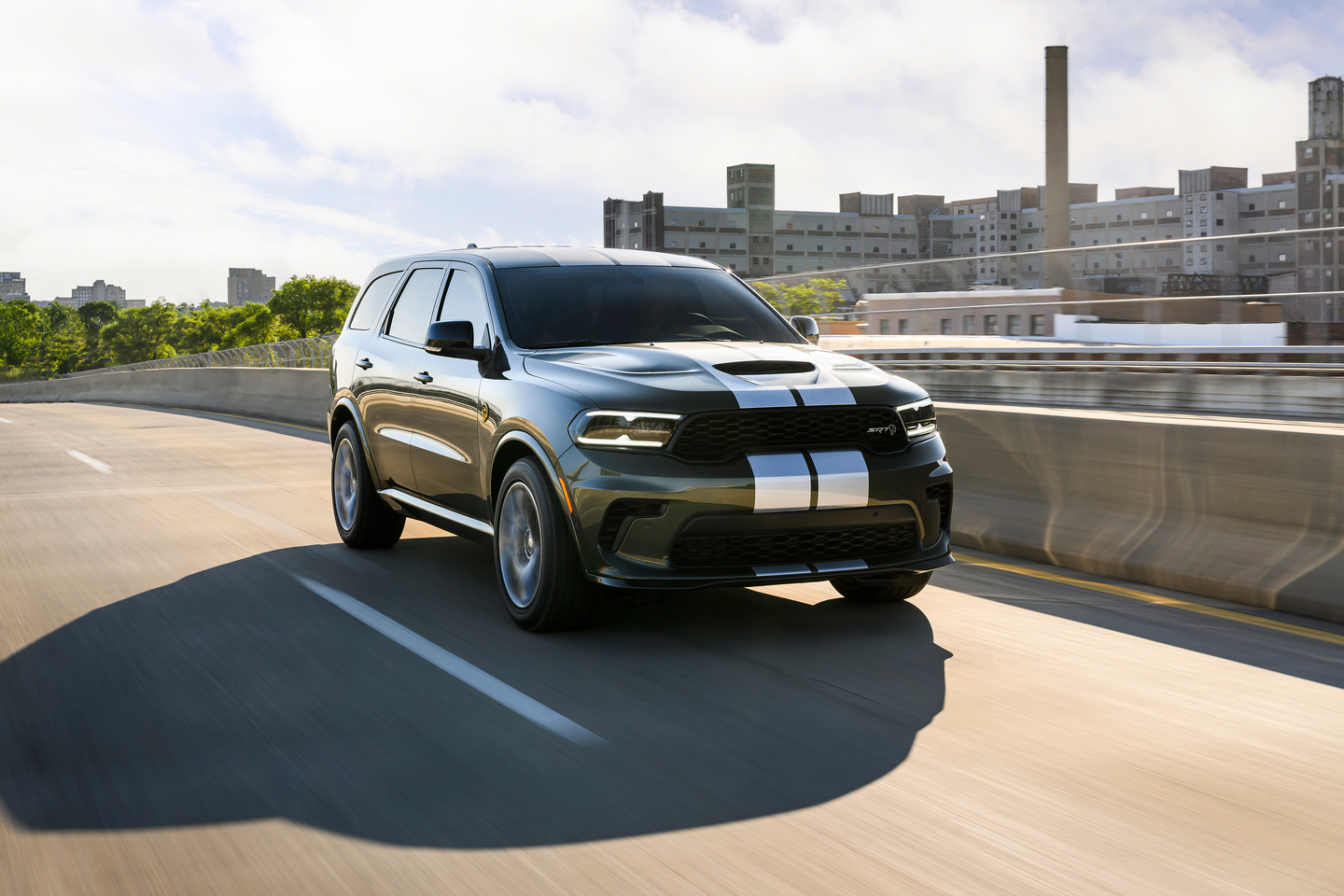 Gray Dodge Durango with racing stripes on a highway
