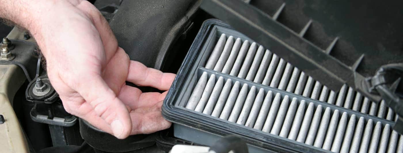 man checking air filter