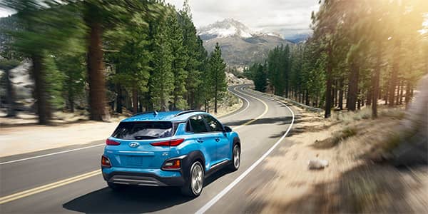 2019 Hyundai Kona SUV driving through a foresat