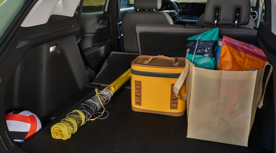 Open trunk cargo area of the 2026 Chevy Trax loaded with reusable grocery bags, a cooler, and sports gear, highlighting 54.1 cubic feet of maximum cargo space and practical utility for South Jersey commuters near Cherry Hill, Marlton, and Mount Laurel Township.