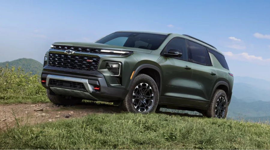 Off-road-capable 2027 Chevrolet Traverse Z71 trim in green with all-terrain tires and front skid plate parked on an outdoor trail near Marlton, available at Elkins Chevrolet in New Jersey.