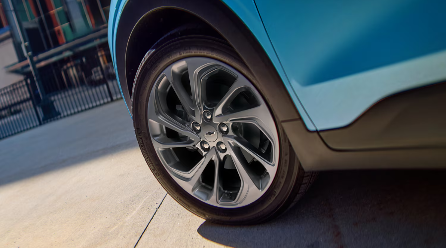 Close-up of the stylish 17-inch alloy wheel and metallic blue paint on the 2027 Chevy Bolt exterior, available at Elkins Chevrolet near Cherry Hill and Marlton, NJ