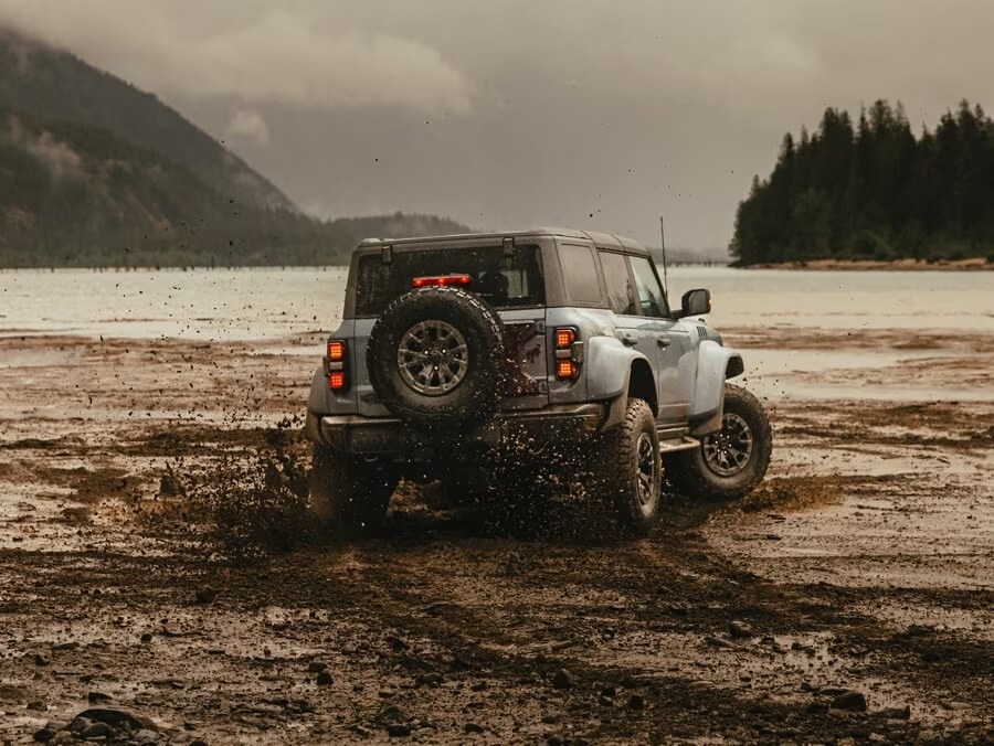 Ford Bronco driving through mud