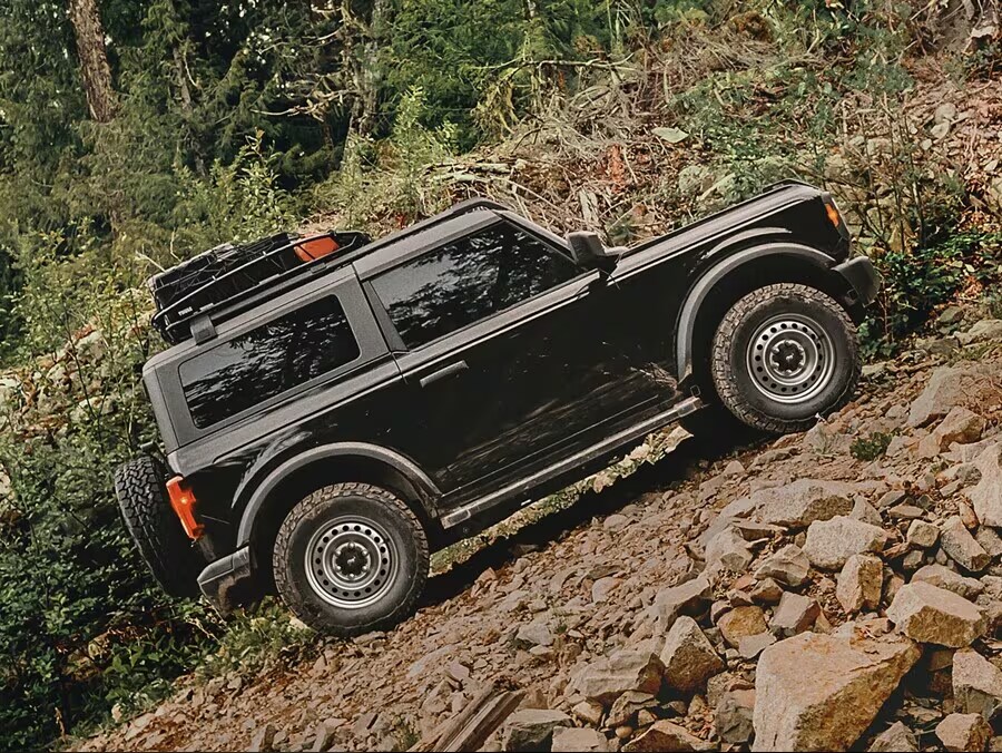 Ford Bronco driving on a steep incline on rocky terrain