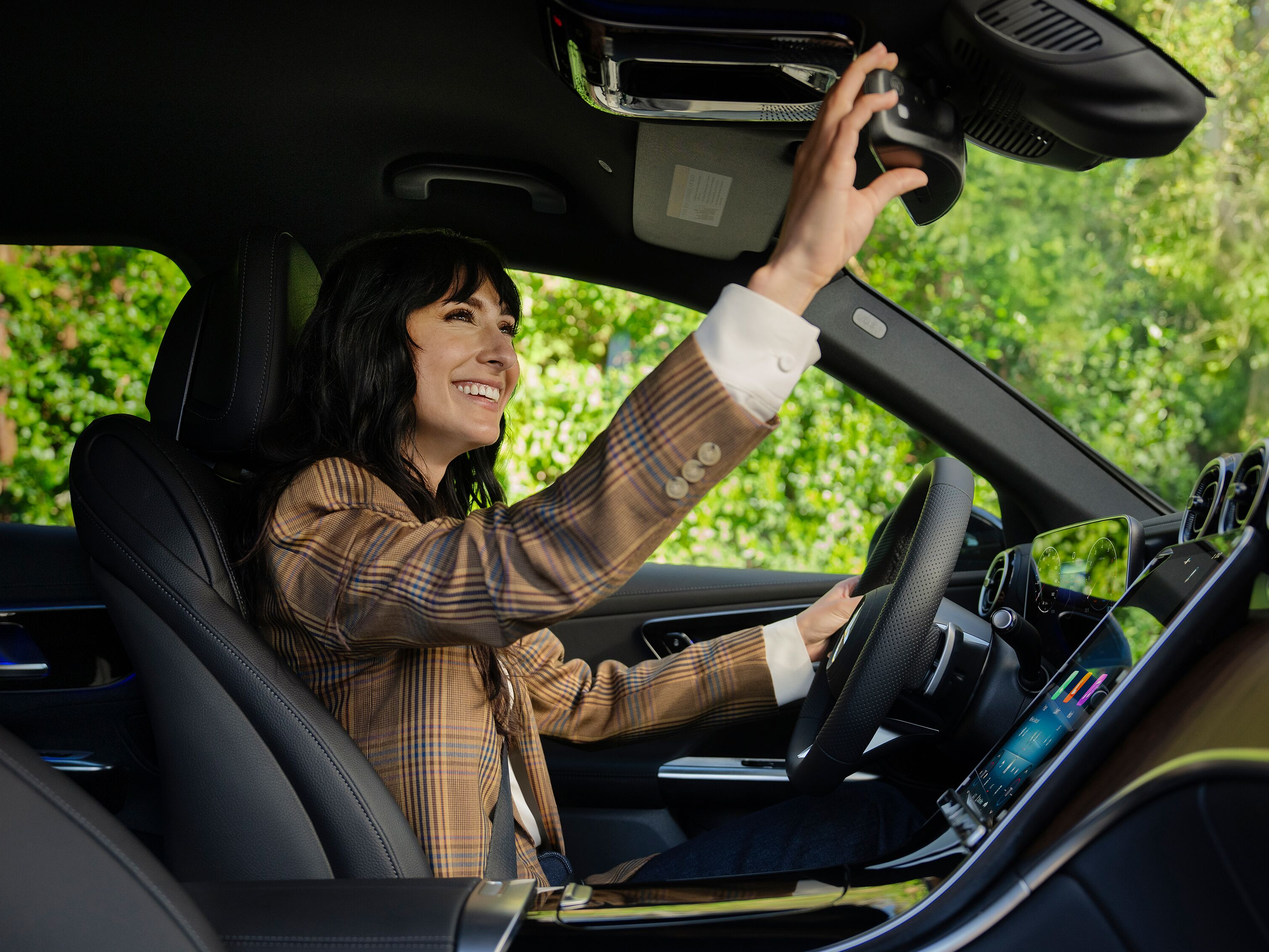 Smiling woman inside of a Mercedes-Benz