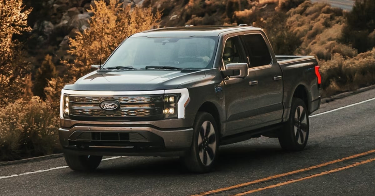 Ford F-150 exterior in grey driving past fall foliage on a highway