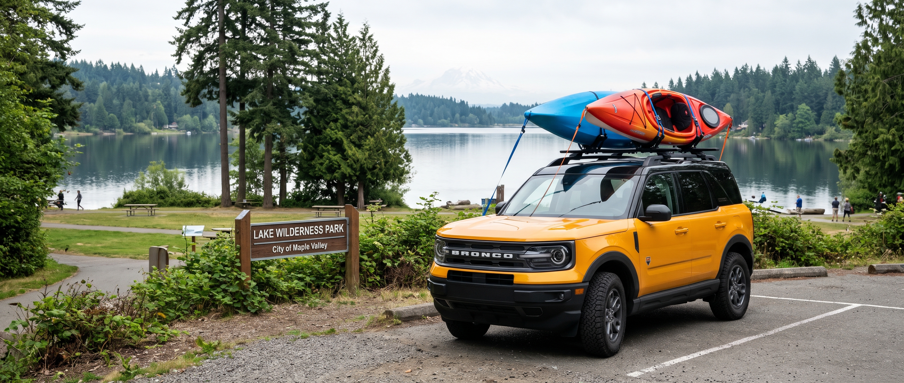 Ford Bronco Sport with kayaks on the roof rack parked near Lake Wilderness in Maple Valley, WA