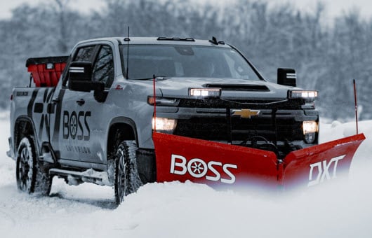 BOSS DXT snow plow on Chevy truck plowing snow in Auburn Maine at Auto City of Maine