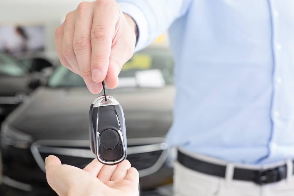 handing keys after auto purchase in dealership
