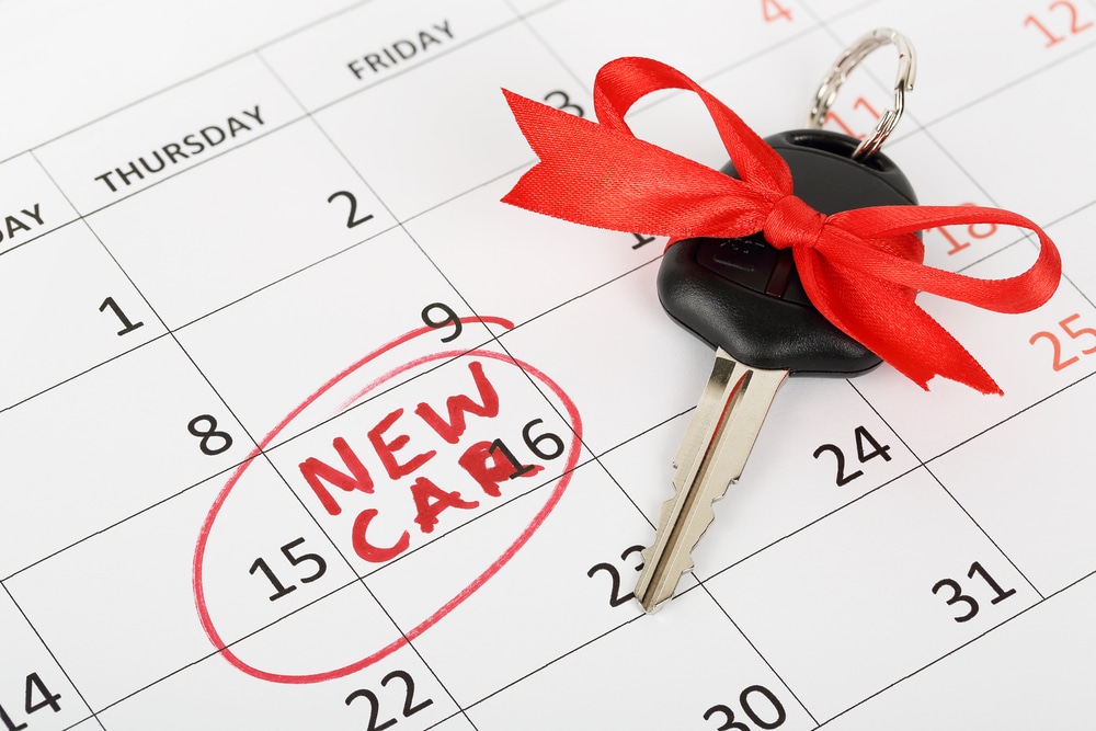 Car%20key%20with%20red%20bow%20on%20a%20calendar%20marking%20NEW%20CAR%20on%20the%2015th%2C%20indicating%20a%20car%20purchase%20or%20delivery%20date.jpg