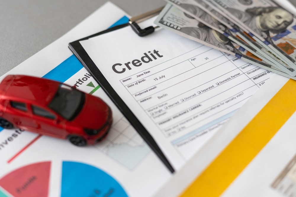 Credit%20application%20form%20on%20a%20clipboard%2C%20cash%20in%20hundred-dollar%20bills%2C%20a%20red%20toy%20car%2C%20and%20financial%20charts%2C%20symbolizing%20credit%2C%20loans%2C%20and%20financial%20planning.jpg