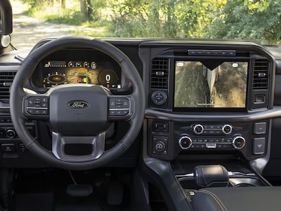 2025 Super Duty® hitched to a horse trailer with a horse and person at the back.