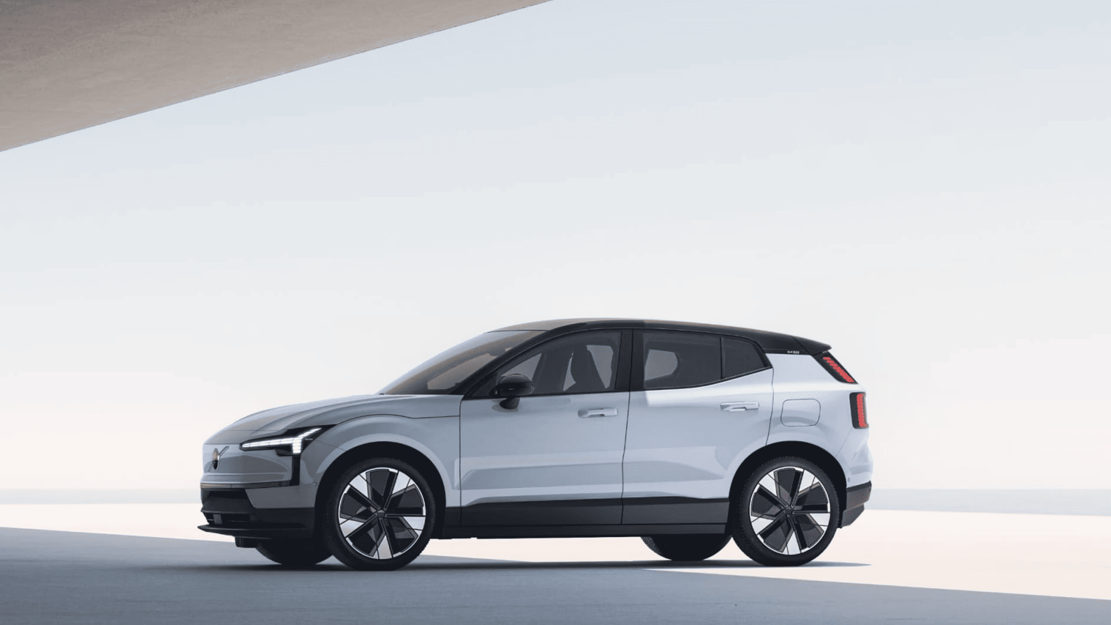 2025 Volvo EX30 compact electric SUV shown in white with sleek, modern design in daylight setting