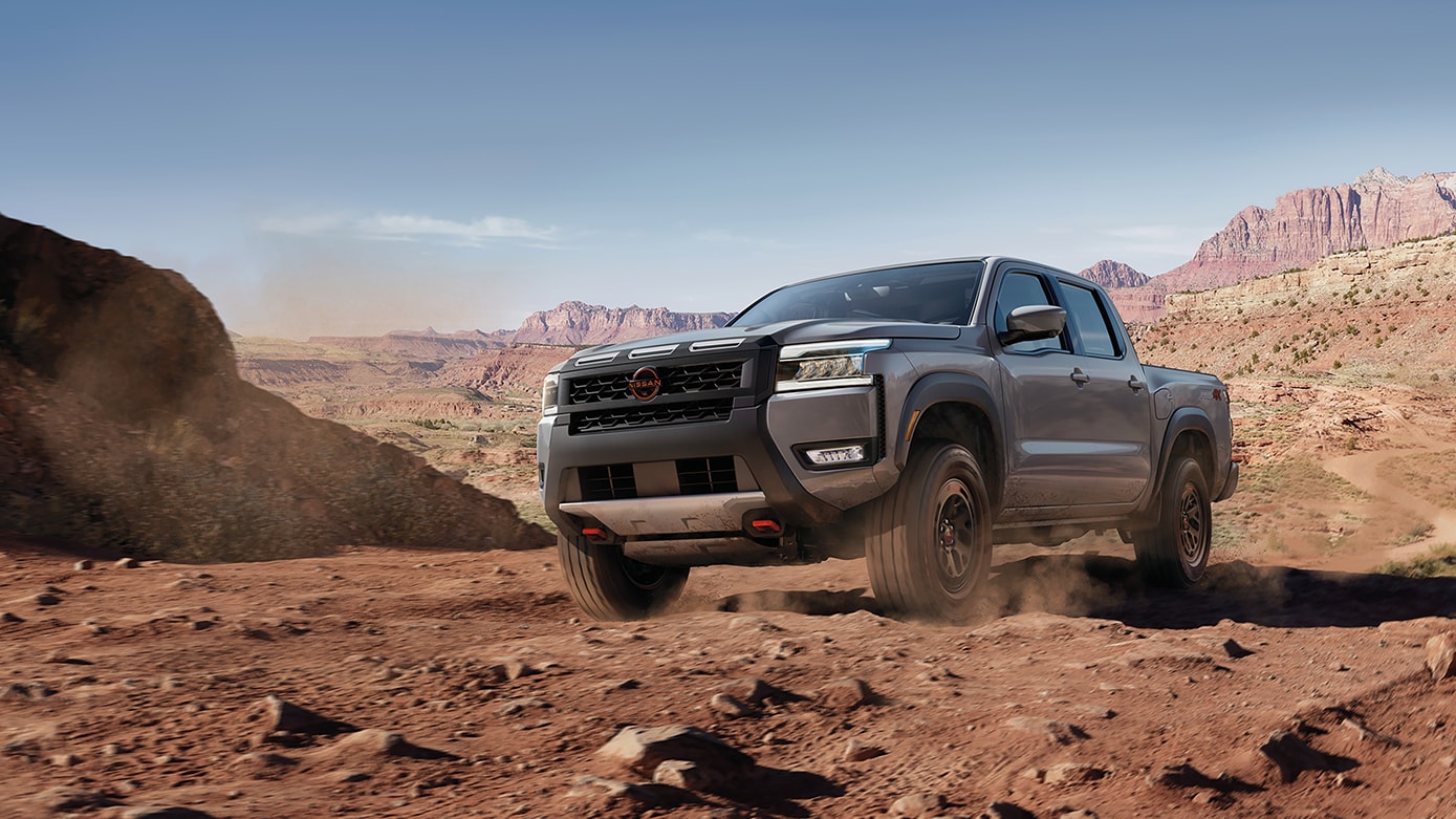 Gray 2025 Nissan Frontier driving off-road
