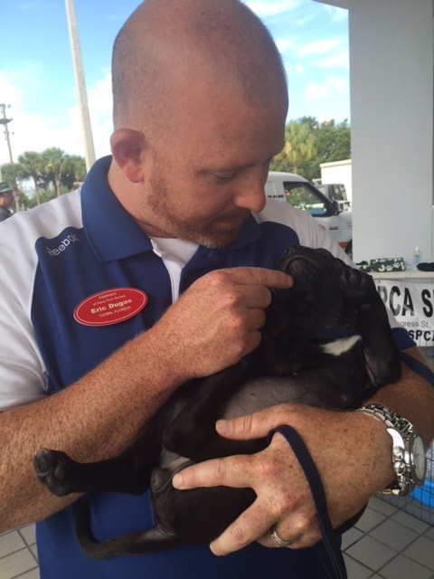 Photo of Ferman New Port Richey employee with Dog at Pawsitively Unbeatable Adoption Event