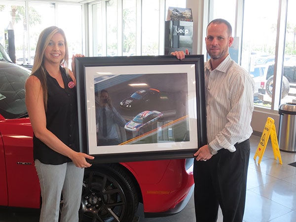 Photo of a Ferman New Port Richey receiving a framed posted from Racing 4 Vets