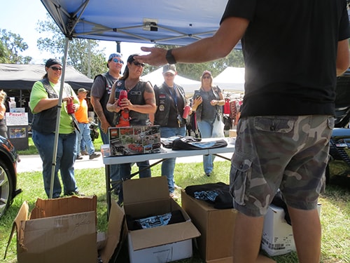 photo of Ferman Volvo handing out complimentary t-shirts at Cotee River Bikefest