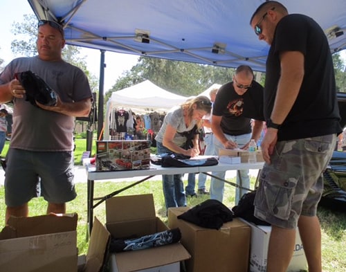 photo of Ferman Volvo handing out complimentary t-shirts at Cotee River Bikefest