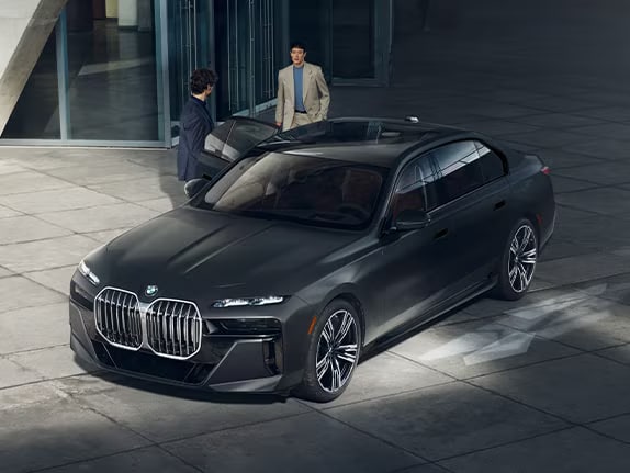 Two people getting into a 2026 BMW 7 Series sedan