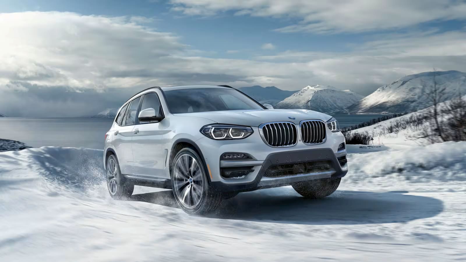 BMW SUV driving in winter snow