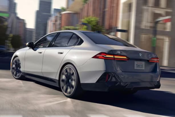 2025-bmw-i5-driving-rear-angle.png