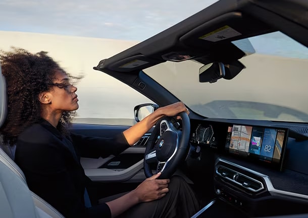 woman driving a pre-owned BMW 4 Series Convertible