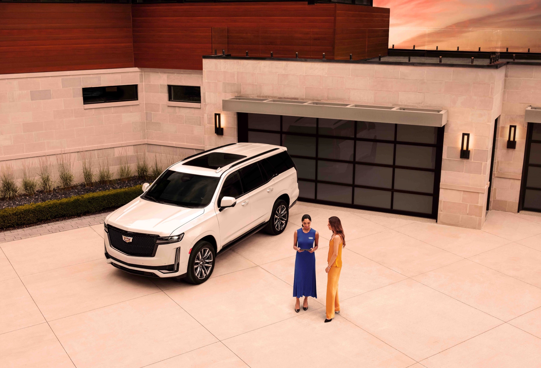 Cadillac SUV, driver, and service technician