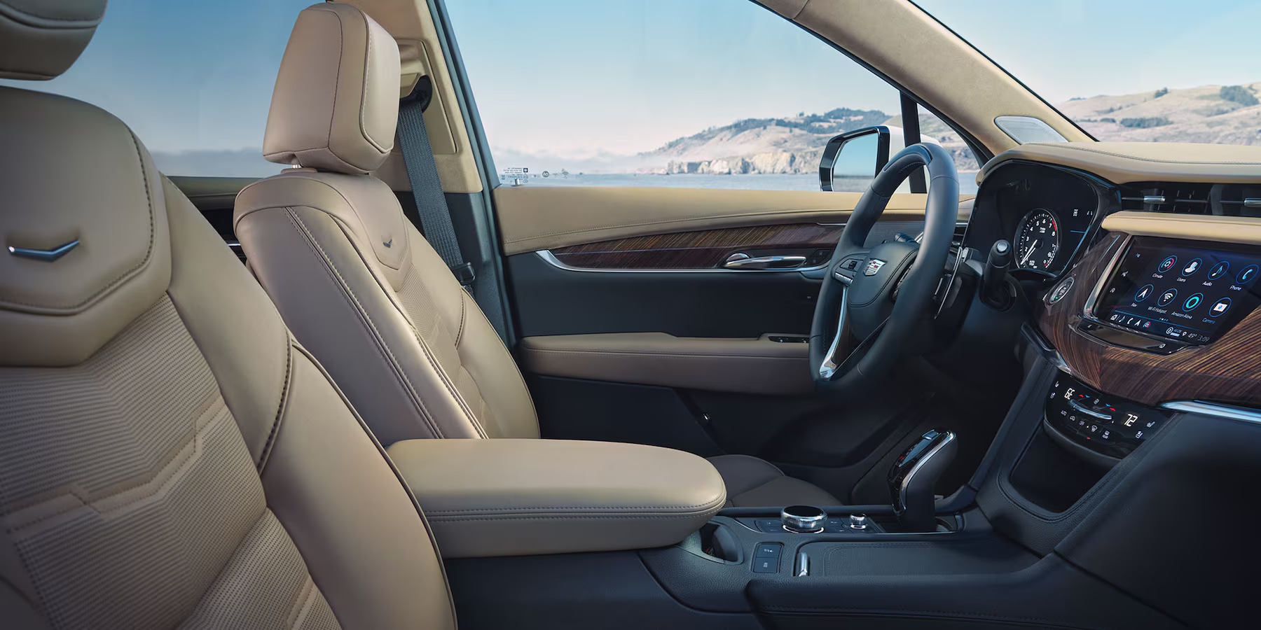 2025-cadillac-xt6-interior-side-view-front-seats.png