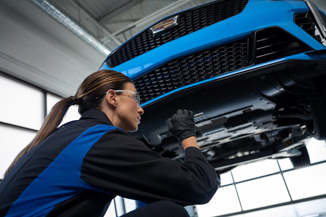 Cadillac technician inspecting a car