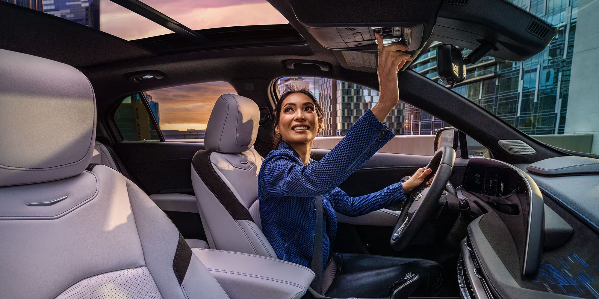 2025-cadillac-xt4-interior-woman-driving-moonroof.png