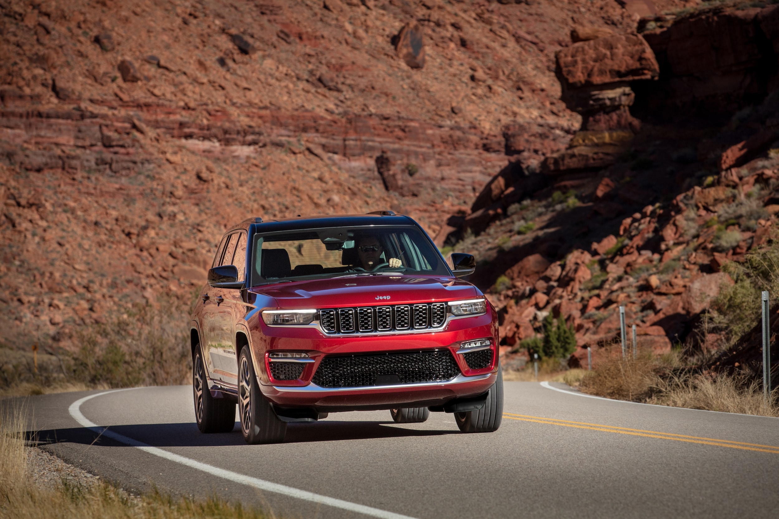 Red 2024 Jeep Grand Cherokee cruising