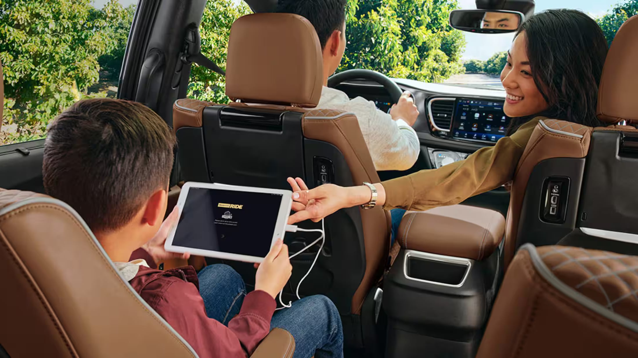 Family exploring the interior of a 2026 Chrysler Pacifica