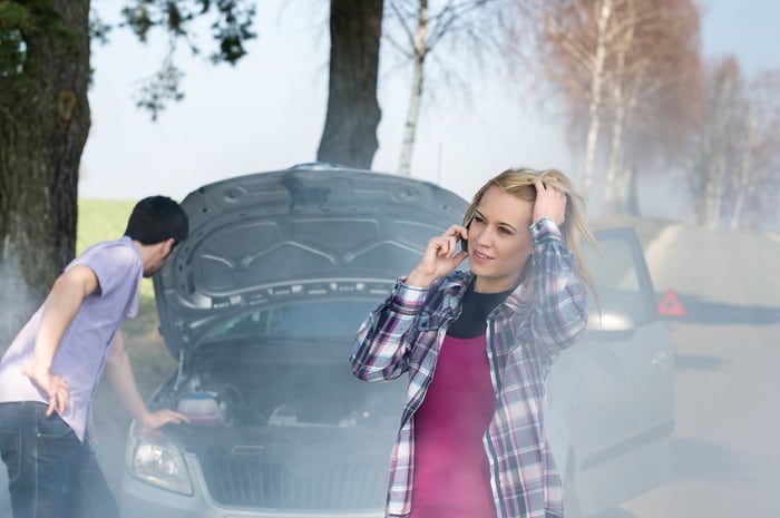 Couple dealing with an overheating engine