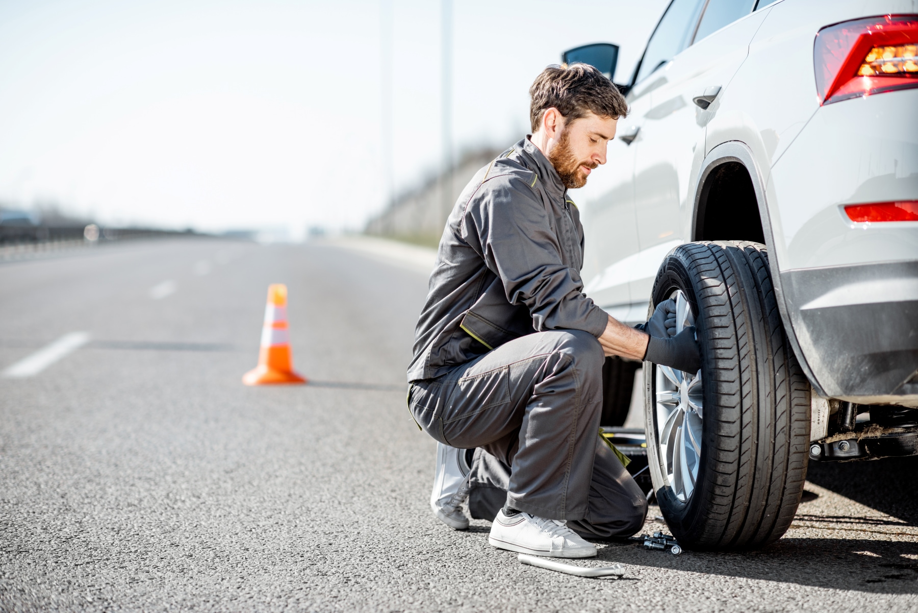 roadside assistance professional changing a tire