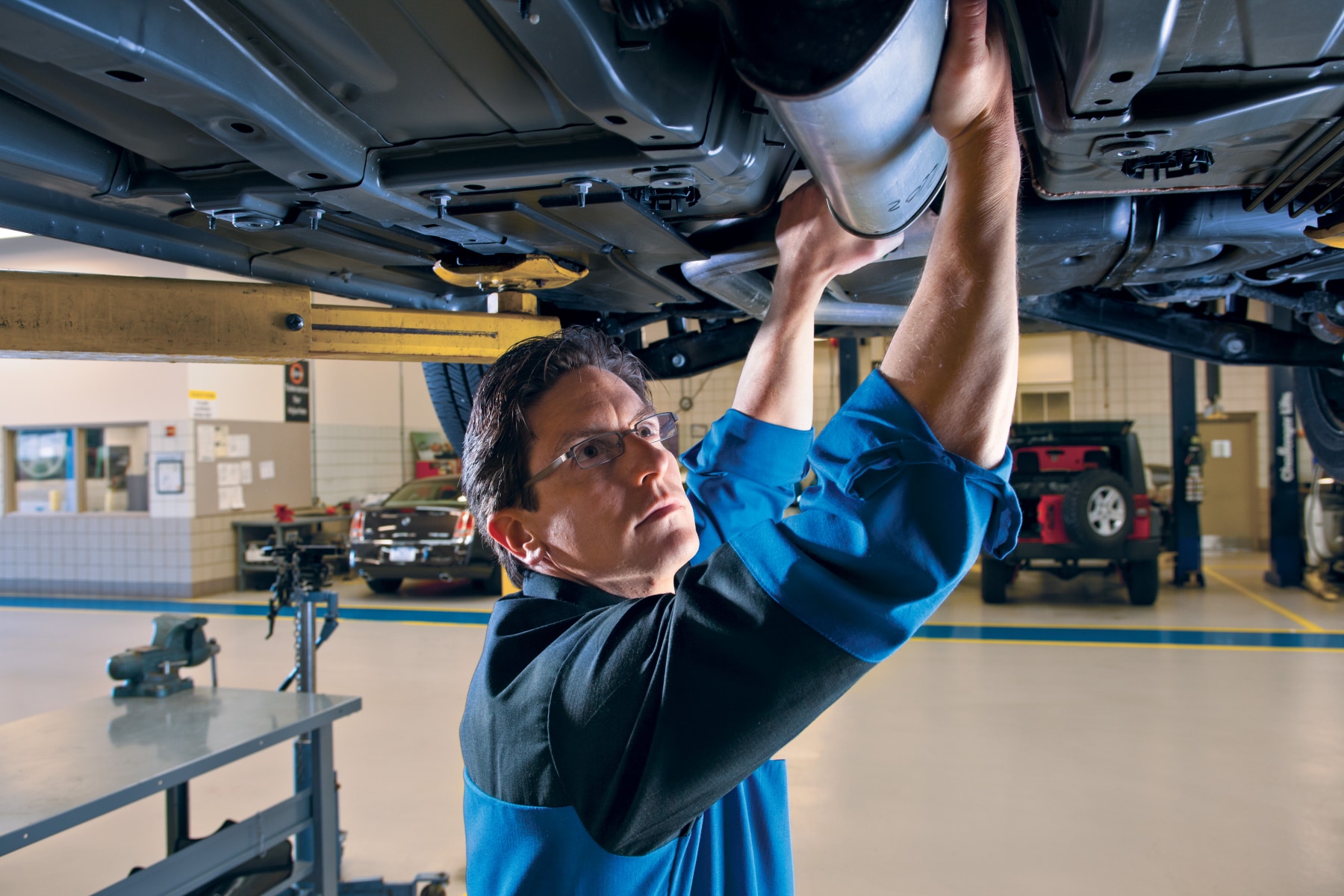 Mopar® technician working on an exhaust system