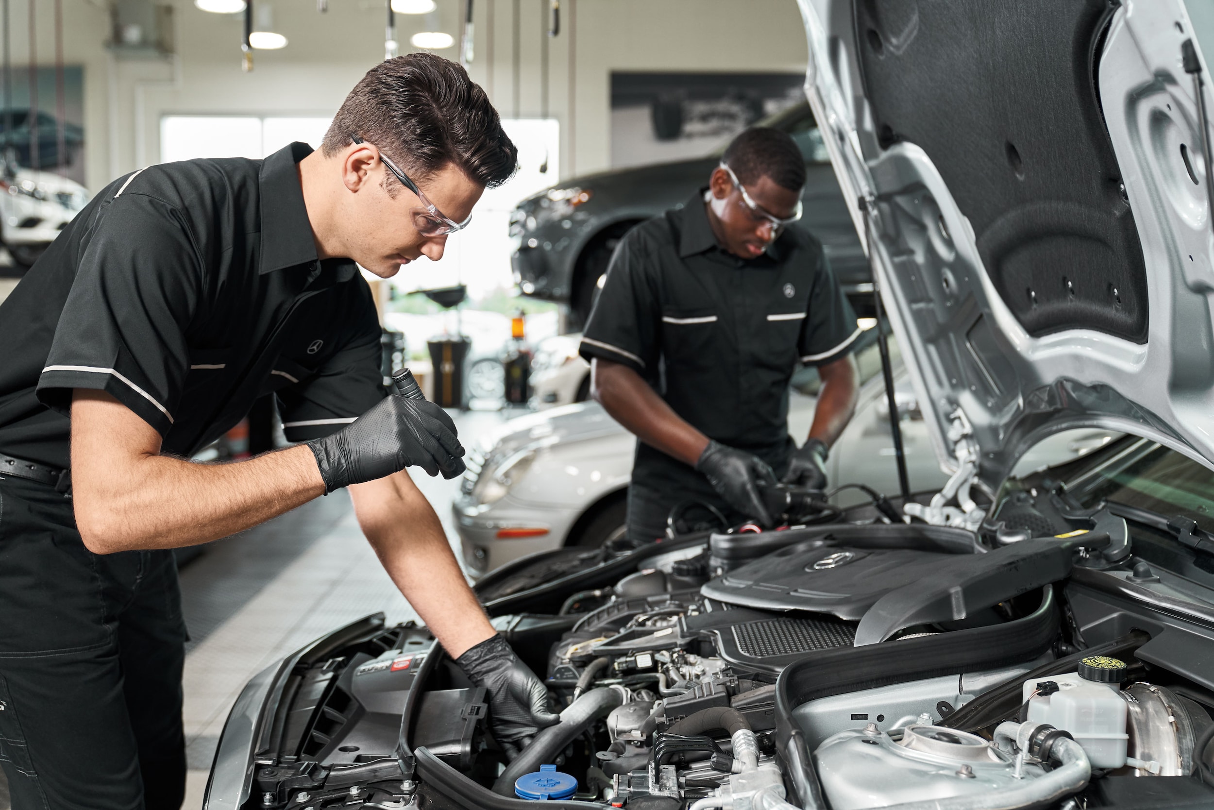 Mercedes-Benz technician performing service inspection