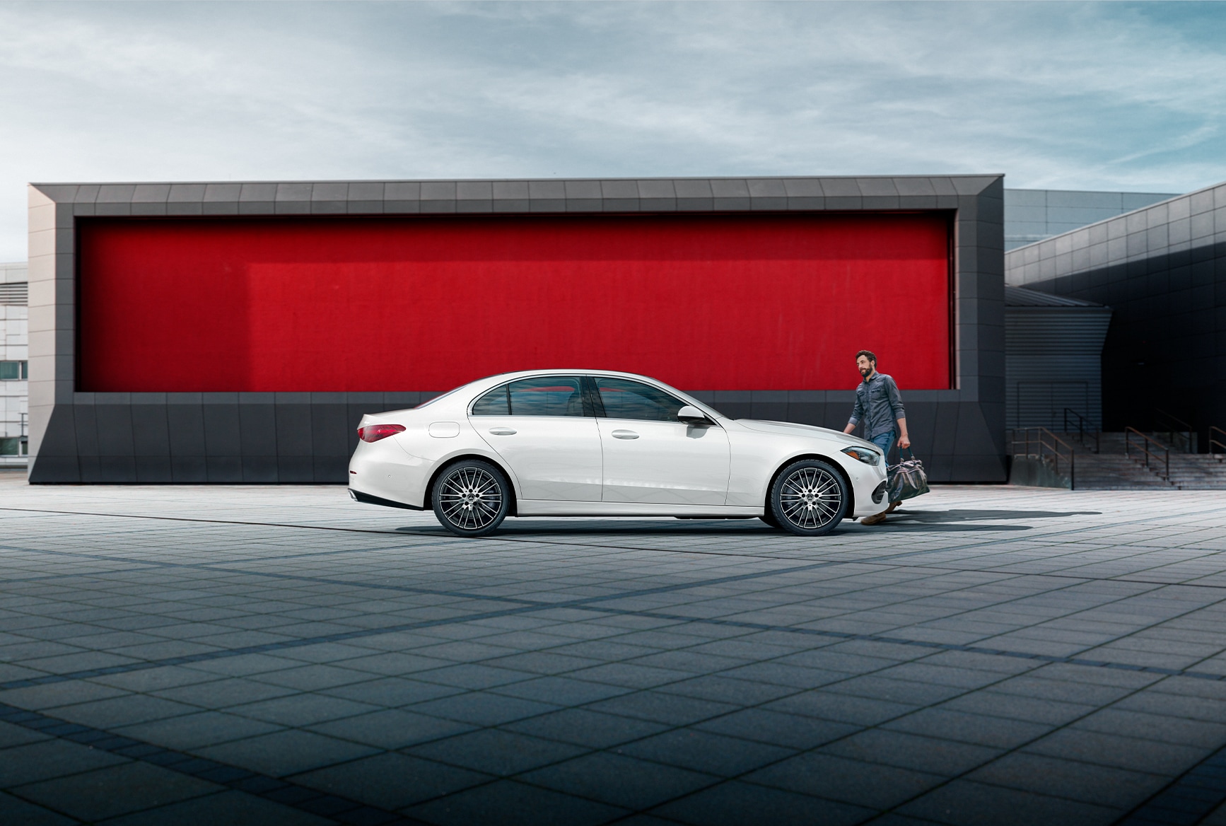 Man going to get into a white 202Mercedes-Benz C-Class