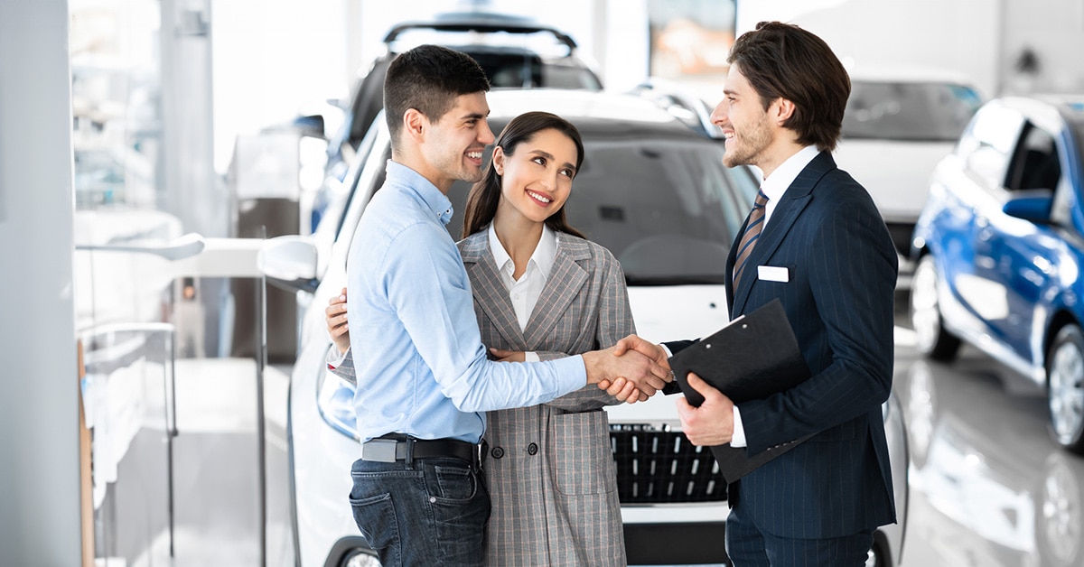 sales expert shaking hands with a couple