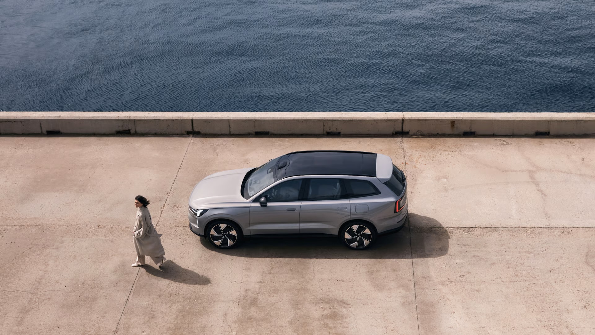 2026 Volvo EX90 and a woman near water