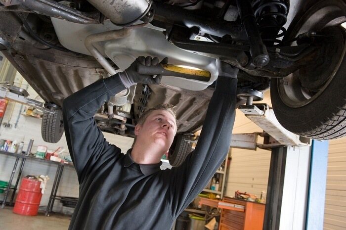 mechanic checking exhaust