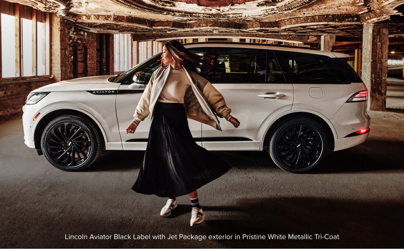 Ford Explorer displays an open liftgate being loaded by a family.