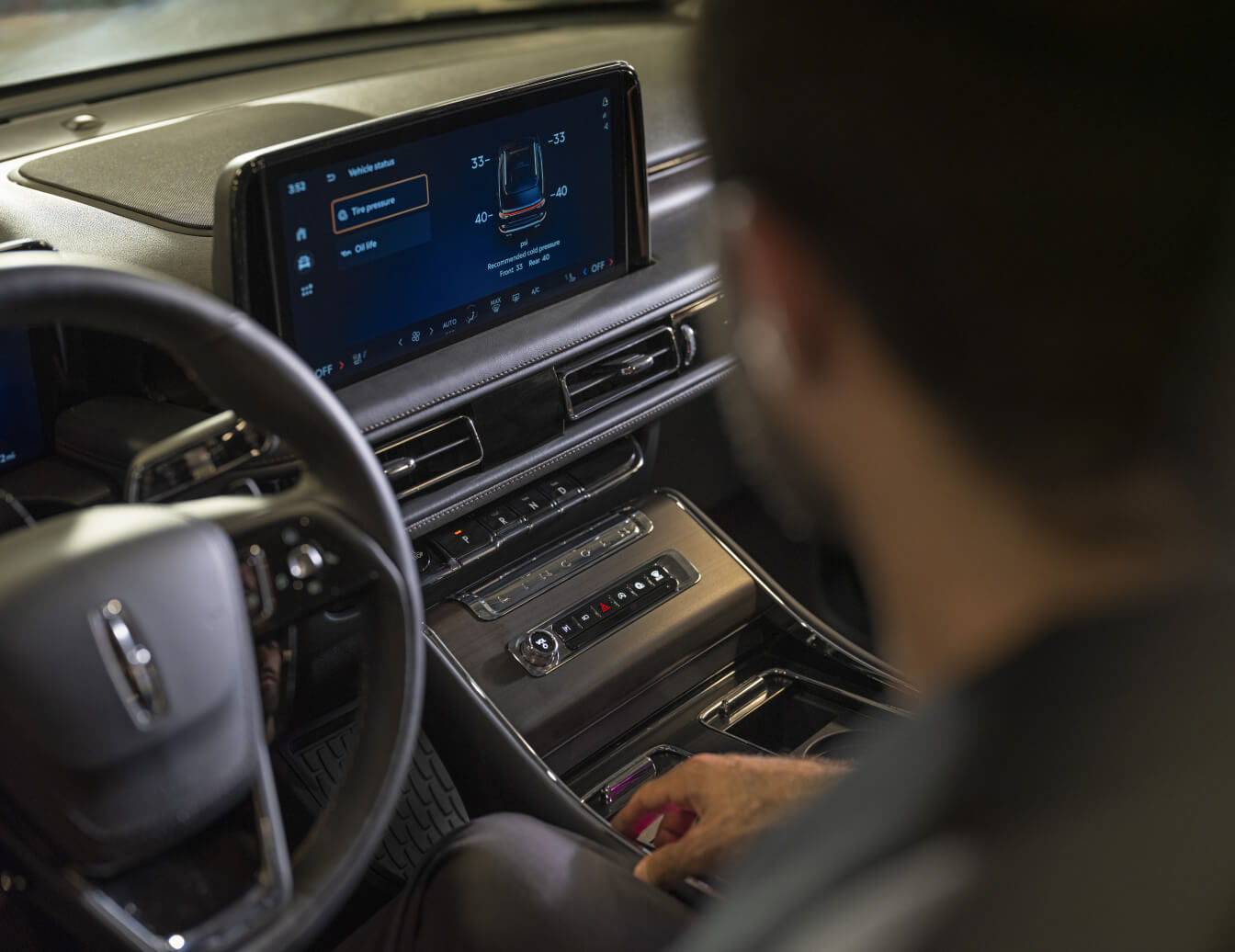 Interior dashboard view of a Lincoln Corsair Grand Touring showing the center touchscreen displaying vehicle tire pressure status.