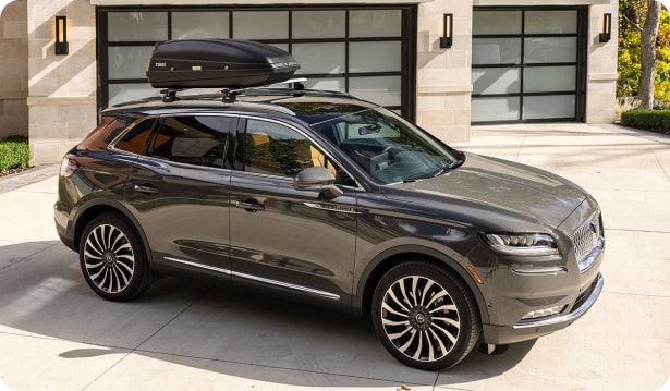 Dark gray lincoln vehicle on a driveway