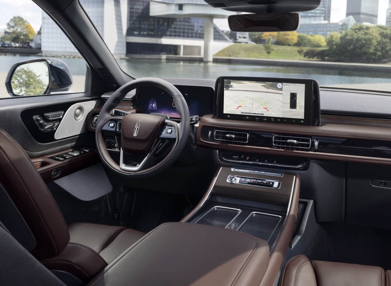 Interior driver-side view of a Lincoln Aviator Reserve in Truffle leather focusing on the digital dashboard.