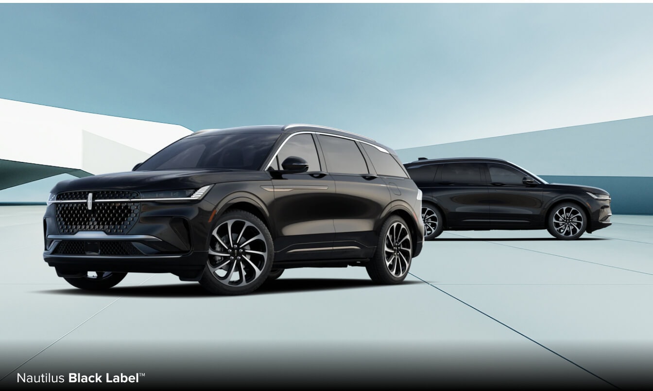 Two black 2026 Nautilus Black Label SUVs parked in a bright modern parking plaza.