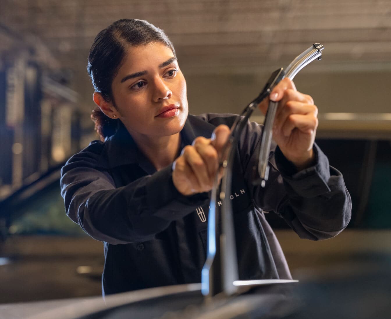 A Lincoln Service Technician replacing a windshield wiper.