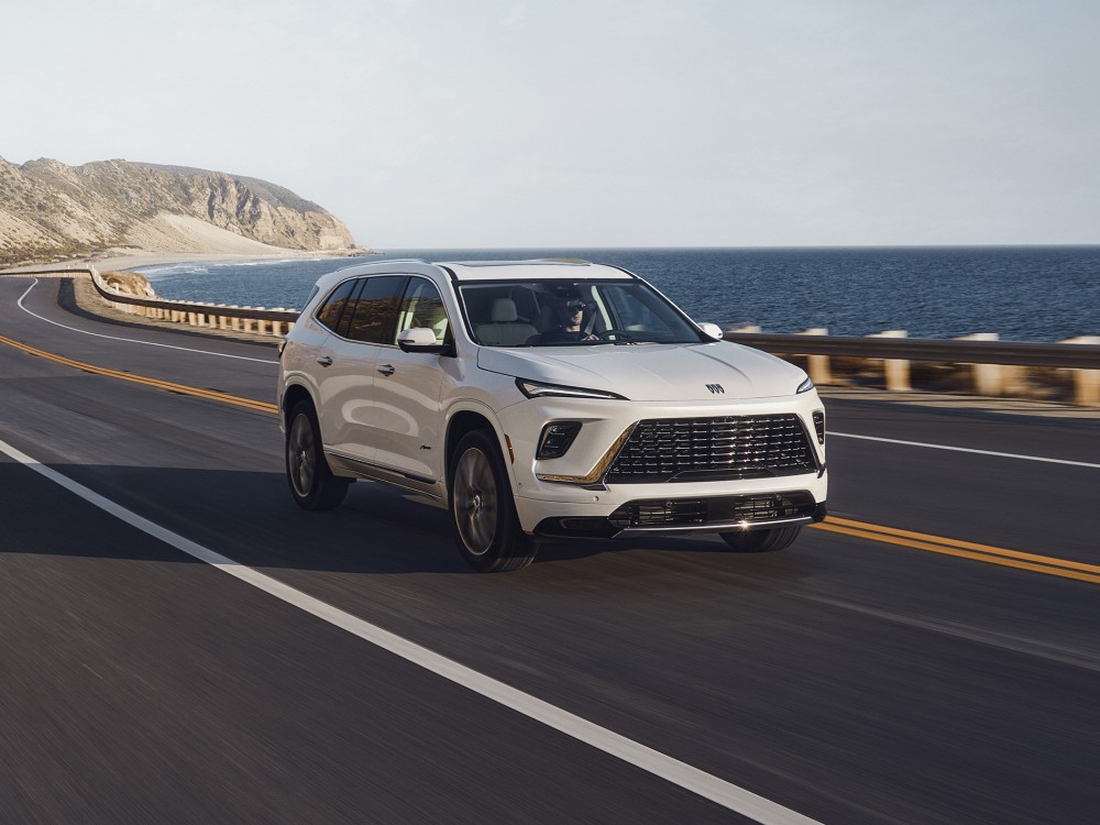  Person driving a new Buick Enclave Avenir by the ocean